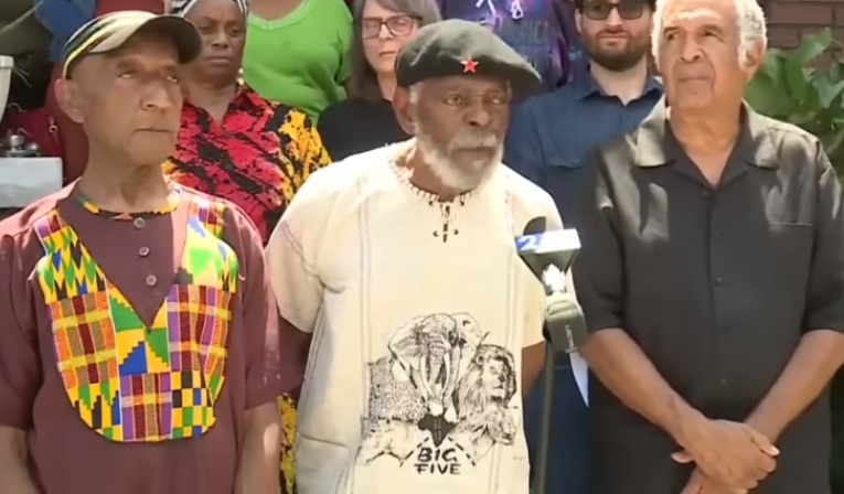 Members of the Uhuru African Socialist Party speak after the FBI raided their home Friday morning.